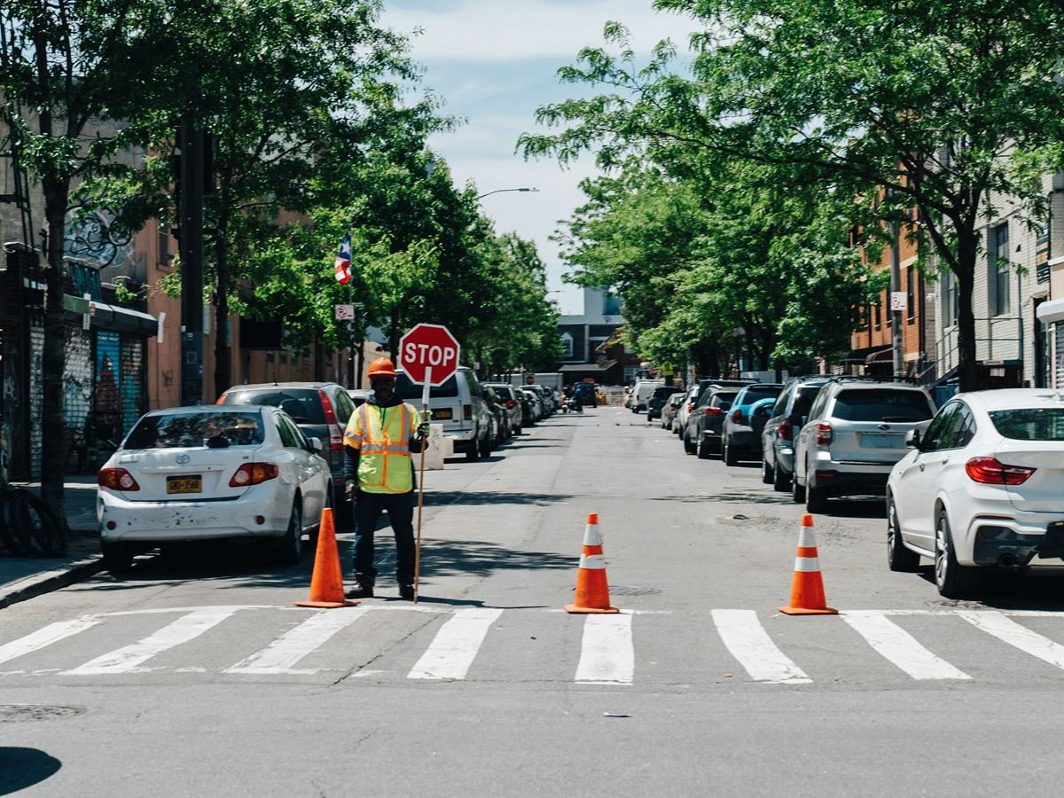 Traffic Control Person holding a STOP paddle at a crosswalk